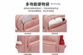 Pink quilted mummy backpack front view on white background