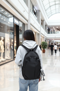 Woman in mall with black minimalist backpack