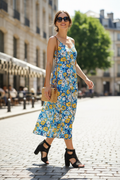 Woman walking in city wearing black cut-out block heel sandals