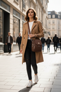 Woman walking with brown crossbody bag