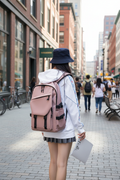 Woman wearing pink utility backpack in city